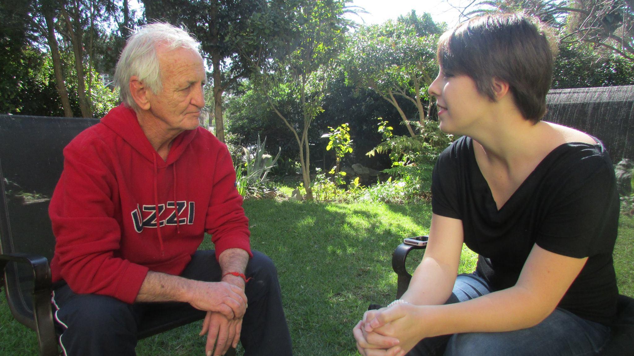 A Journalism intern interviews a local man for a story in Cape Town, South Africa. A local man is interviewed by a student doing a Journalism internship in South Africa.